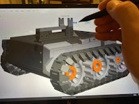 a person is using a pen to draw on a computer screen